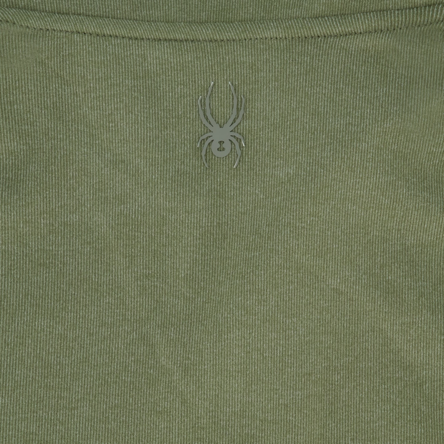 Close-up of a green fabric with a spider logo on it