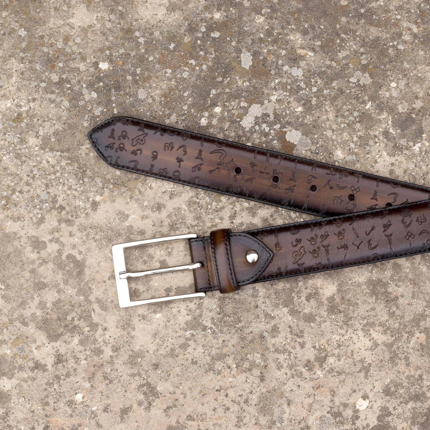 Brown leather belt with silver buckle from Arabic Matrix Patina Hamptons collection