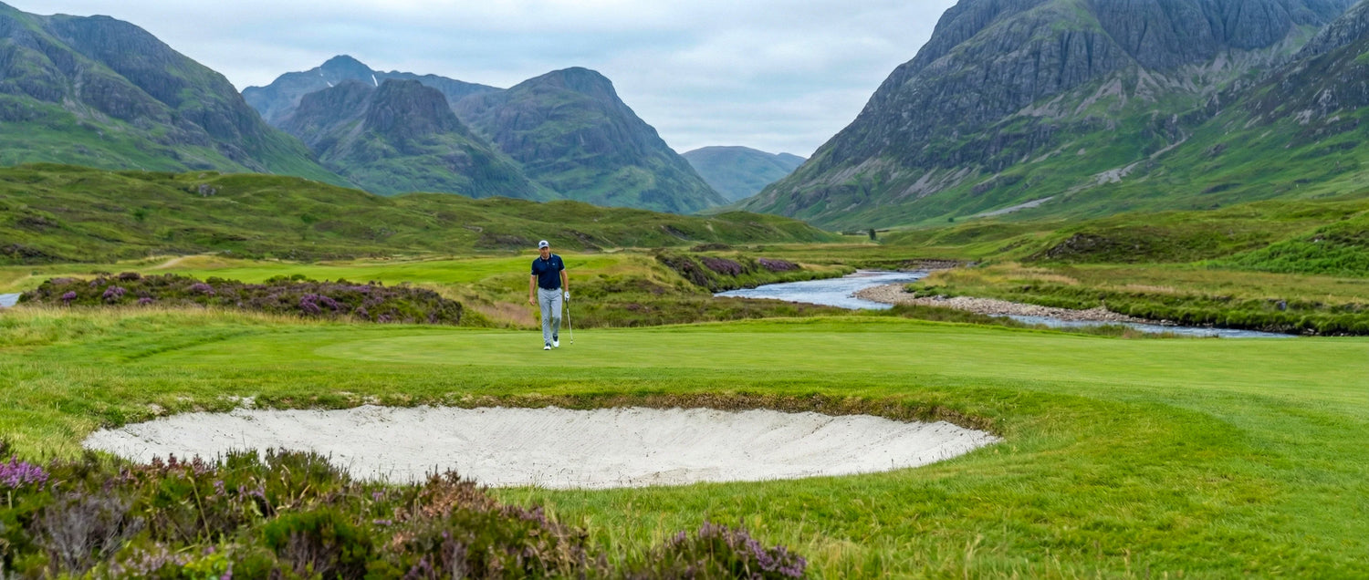 Man golfing on a scenic green golf course with mountains and river, lifestyle for men