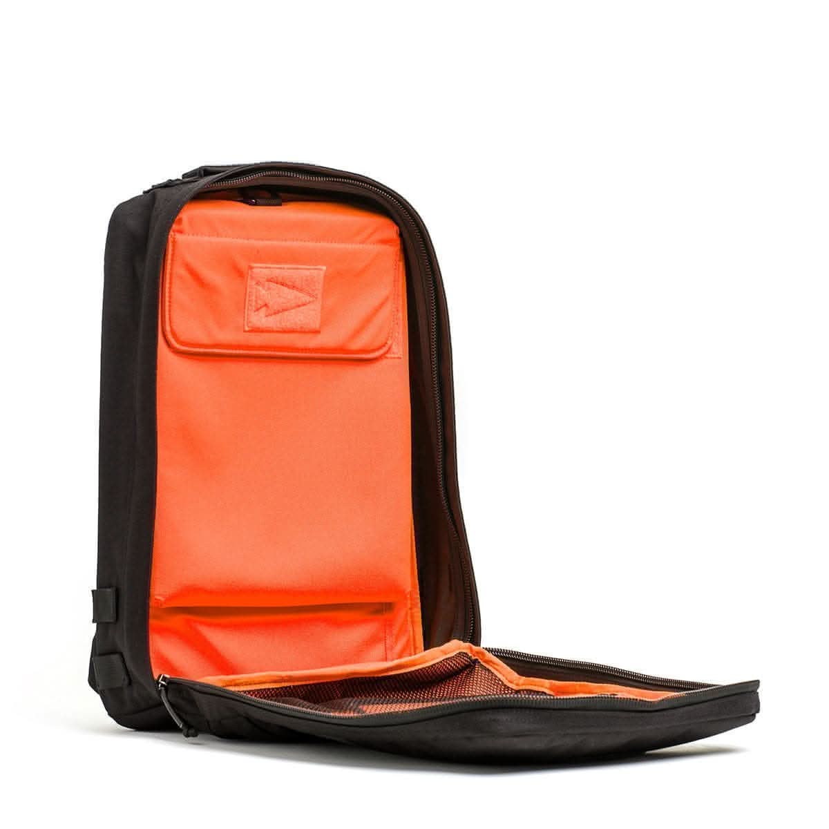Black men's backpack with orange interior, open to show pockets and organization