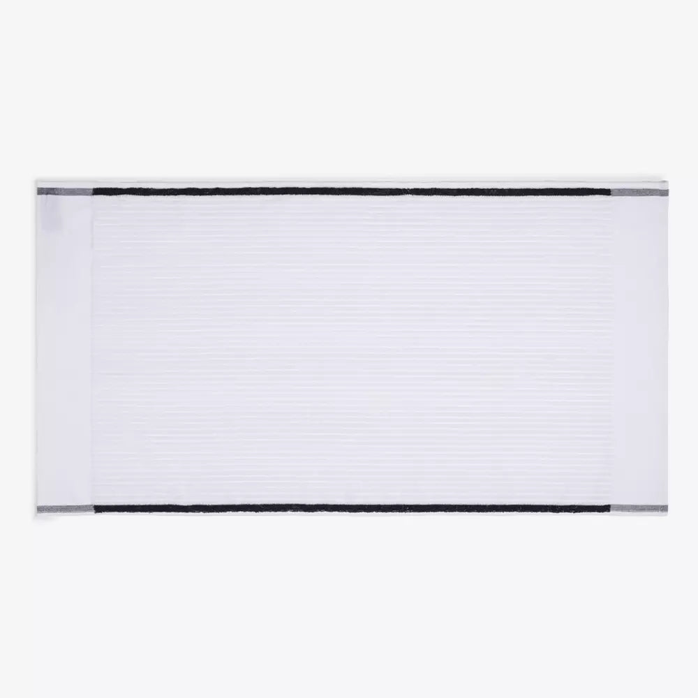 White ribbed bath towel with black border, minimalist men’s grooming accessory