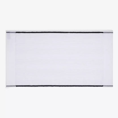 White ribbed bath towel with black border, minimalist men’s grooming accessory