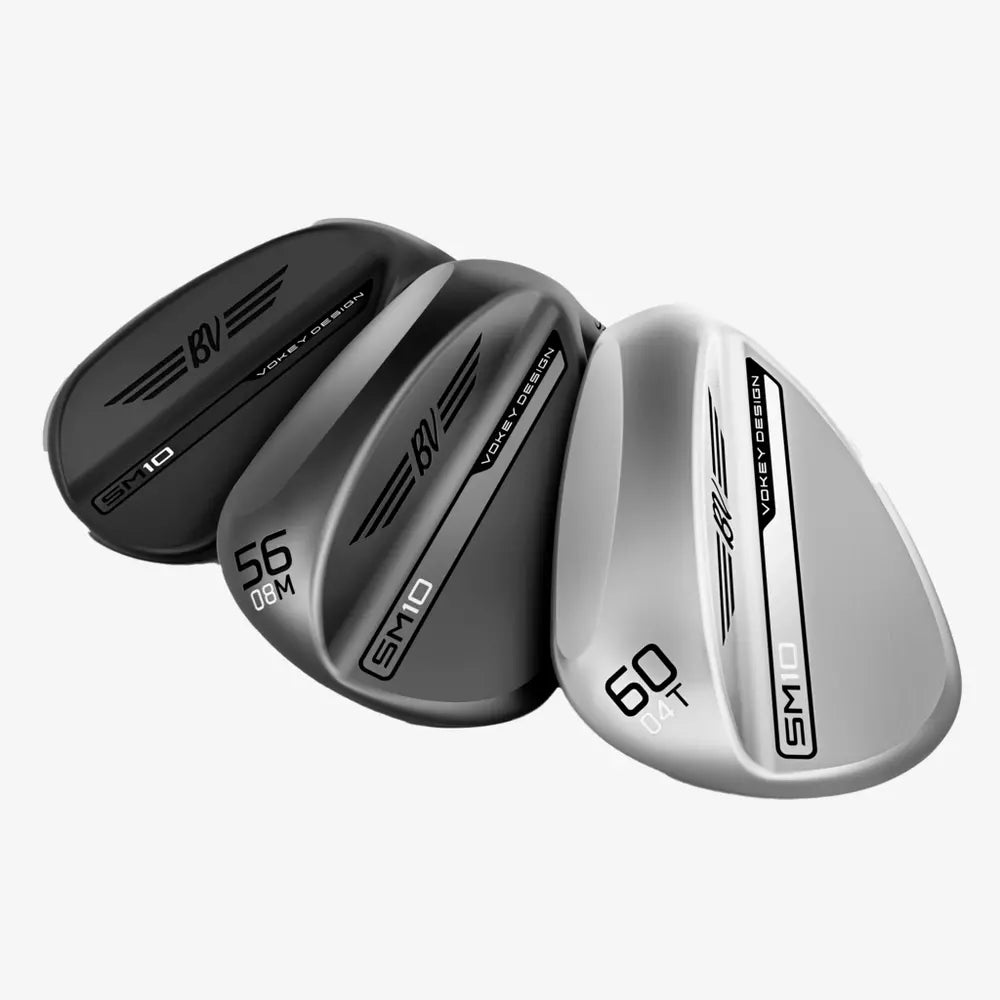 Three Vokey Design SM10 golf wedges in black and silver, angled on white background