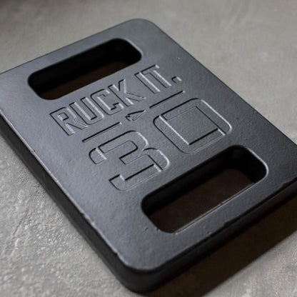 30lb ruck plate with handles for men's fitness, embossed with 'Ruck It.' on concrete