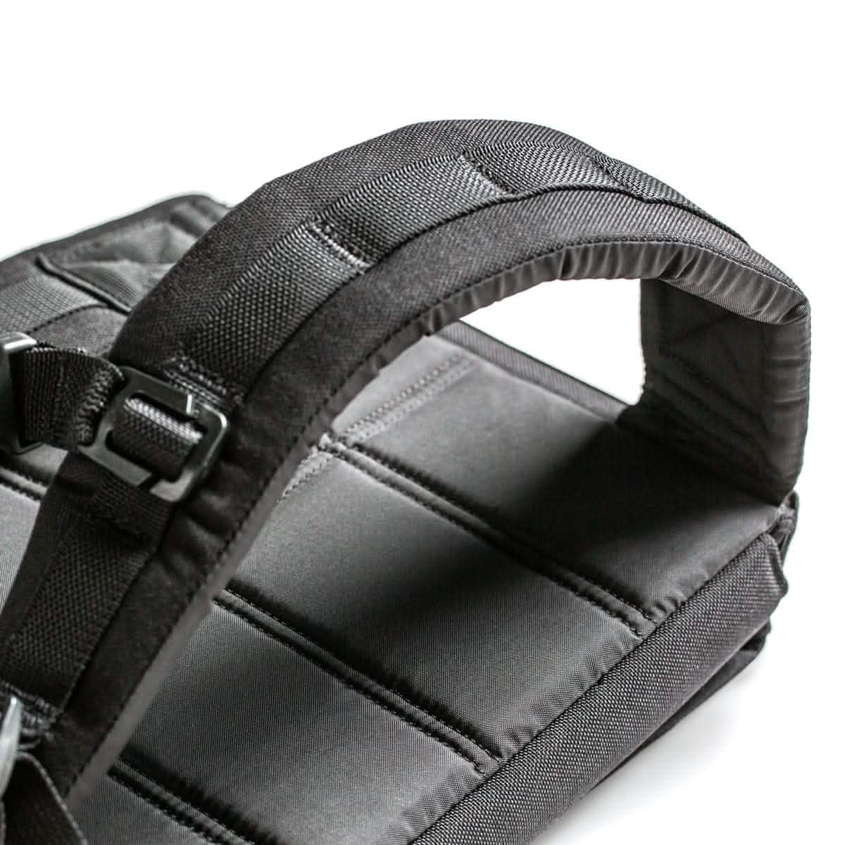 Close-up of padded black ruck plate carrier straps with durable stitching for men