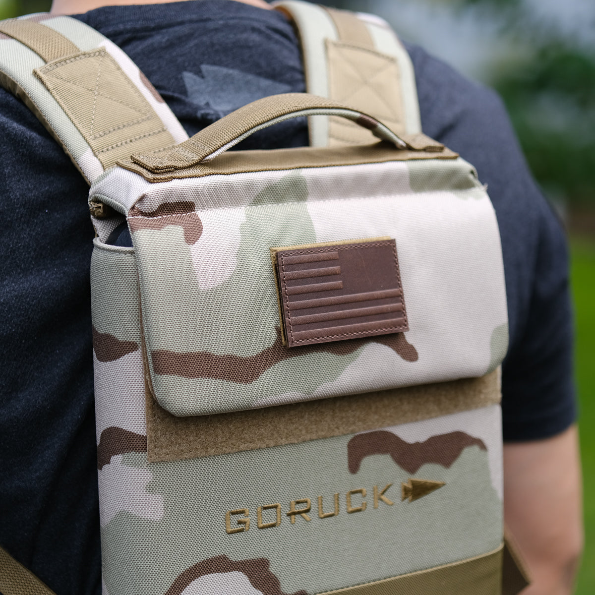 Man wearing GORUCK camo backpack, close-up of stylish outdoor gear for men