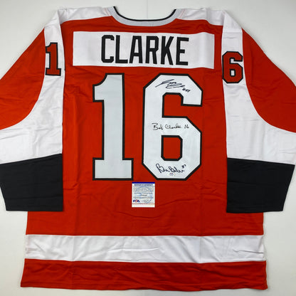 Autographed/Signed Reggie Leach, Bobby Clarke & Bill Barber Philadelphia Orange Hockey Jersey PSA/DNA COA