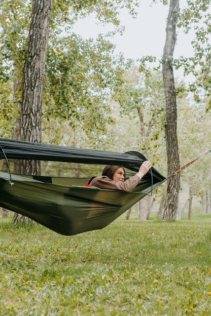 Lightweight hammock with mosquito net for outdoor adventures.