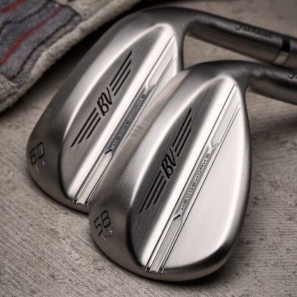 Polished Titleist BV WedgeWorks golf clubs for men on wood surface, stylish lifestyle gear