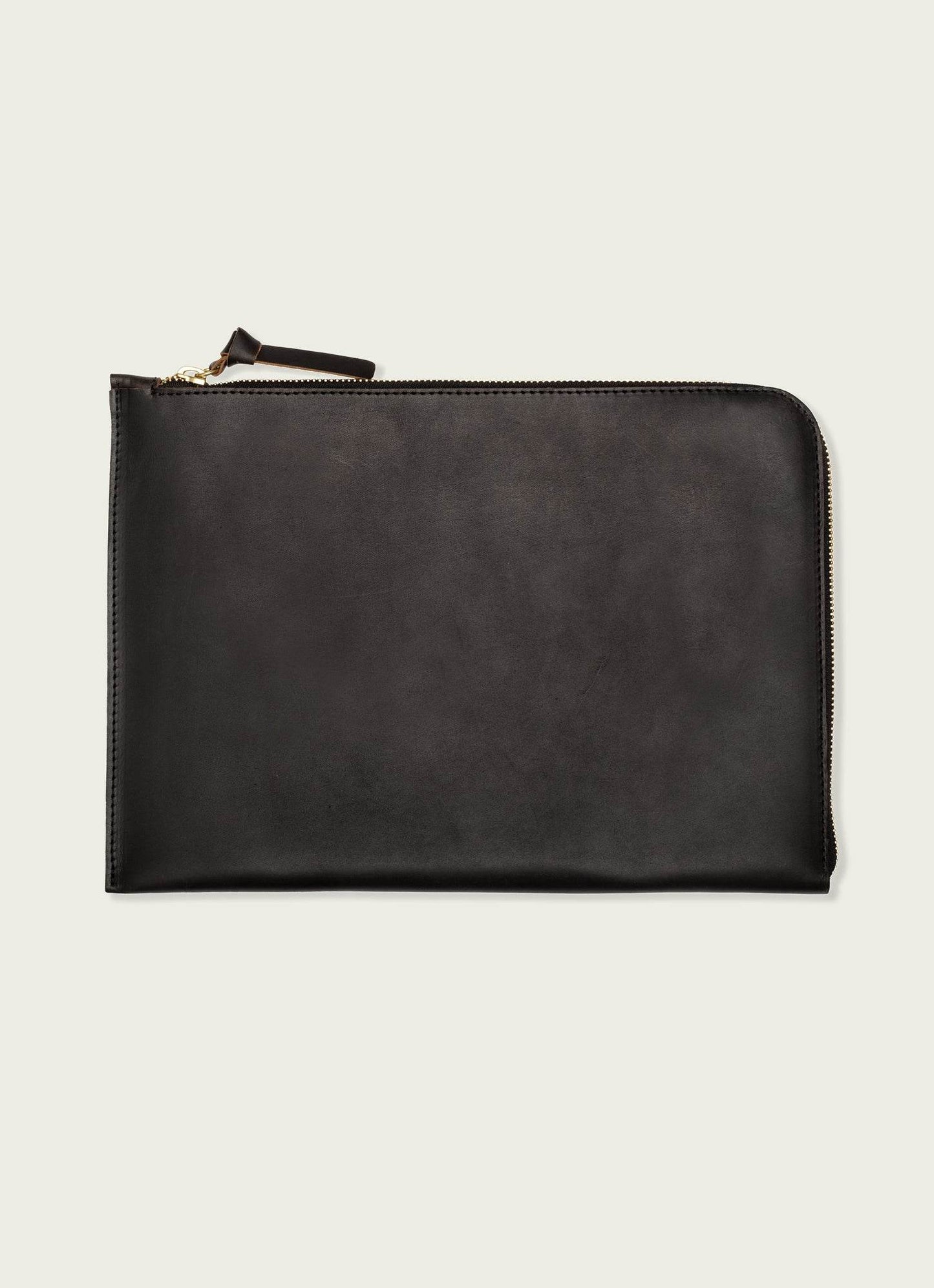 Sleek black leather laptop case with zipper, minimalist men’s accessory on light background
