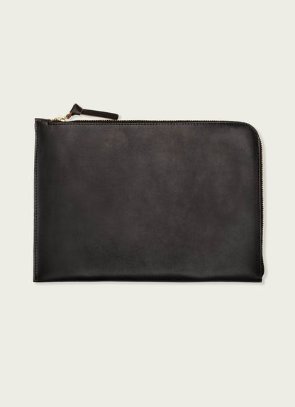 Sleek black leather laptop case with zipper, minimalist men’s accessory on light background