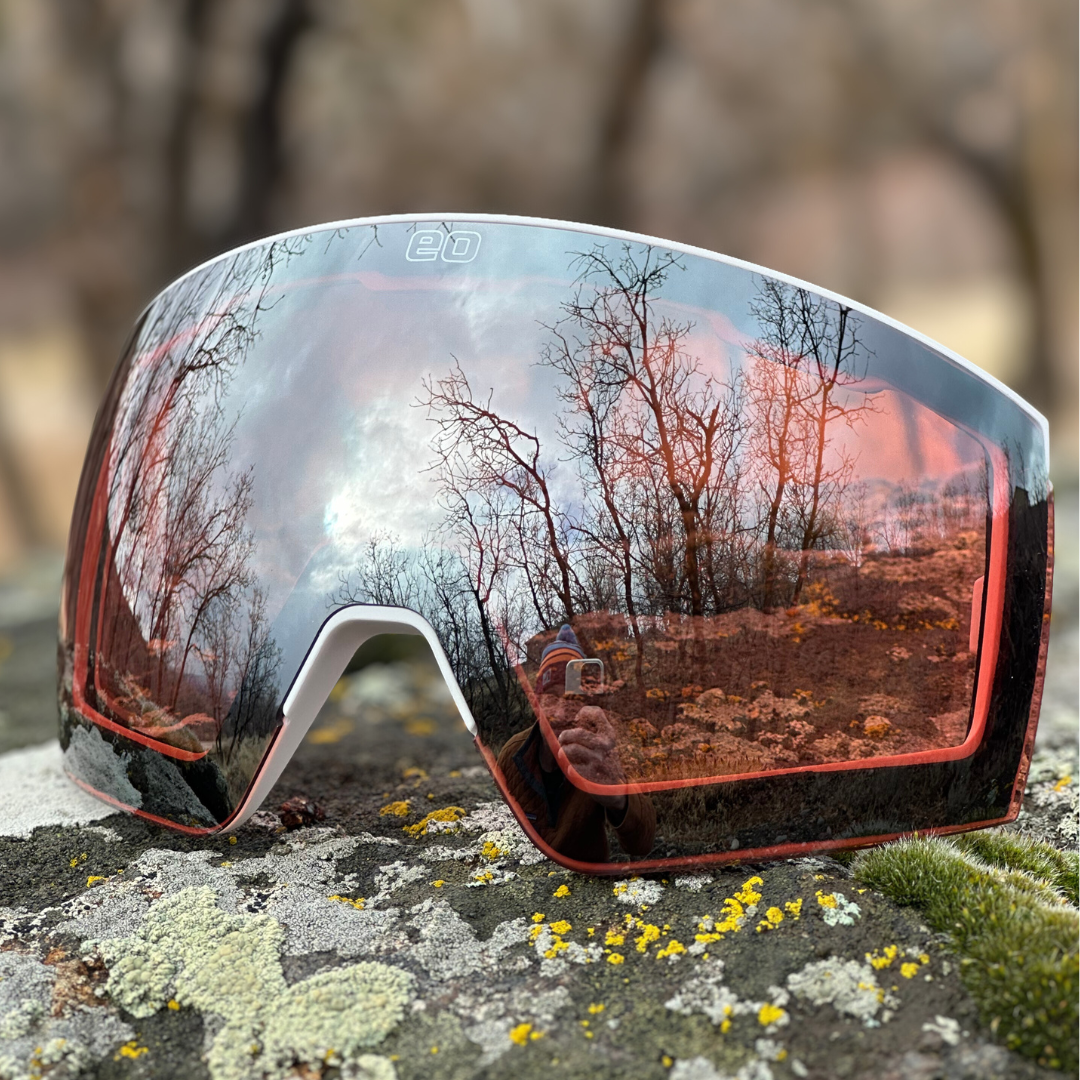 Pink silver mirrored sports sunglasses with nature reflection on rock, men's grooming style