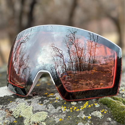 Pink silver mirrored sports sunglasses with nature reflection on rock, men's grooming style