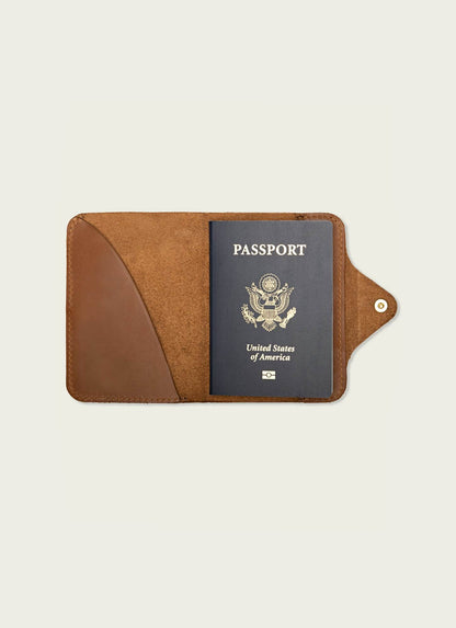 Tan leather men's passport wallet holding a U.S. passport on neutral background