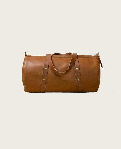 Brown leather duffel bag for men with handles, minimalist style, grooming and fashion accessory