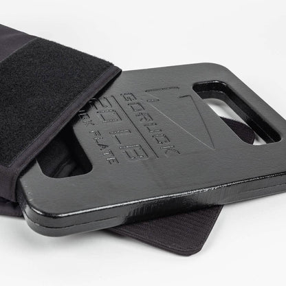 GORUCK 20LB black ruck plate partially inside a tactical backpack, men's fitness gear