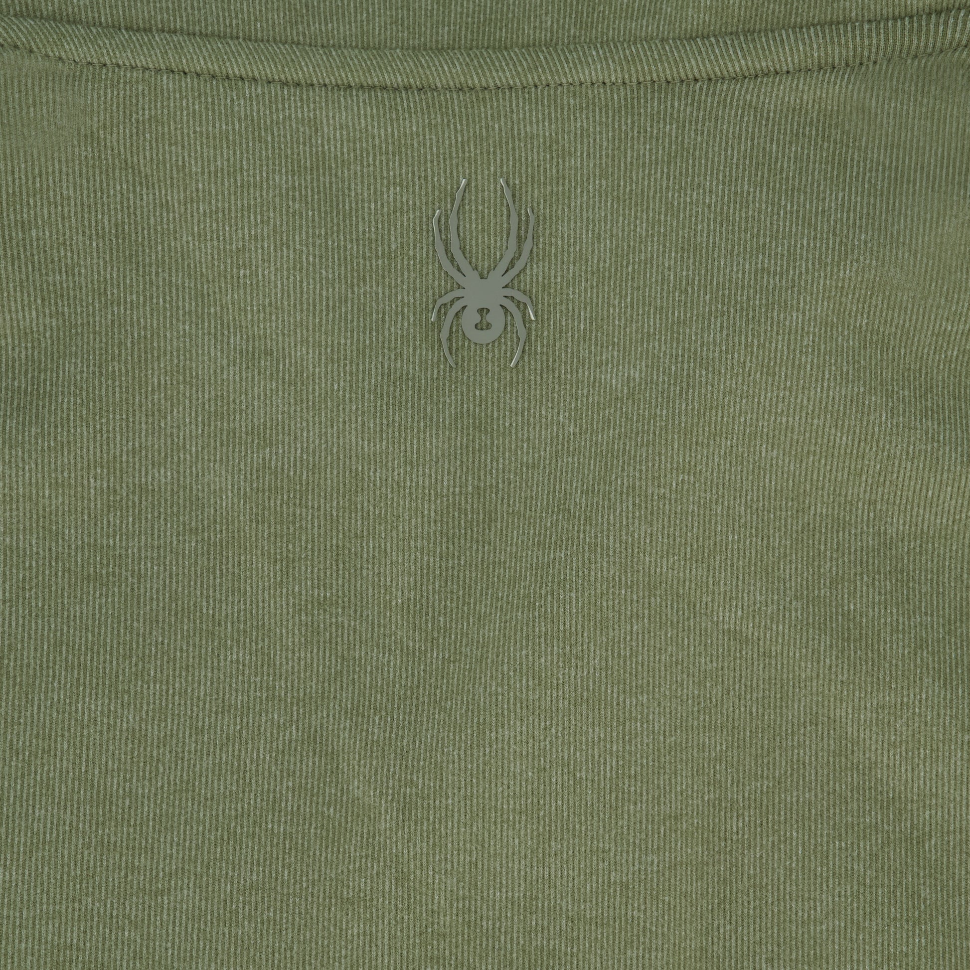 Close-up of a green fabric with a spider logo on it