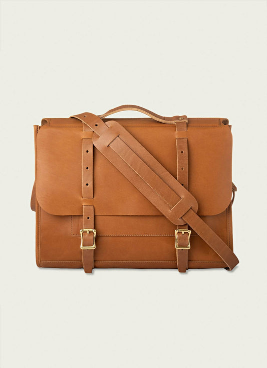 Men's tan leather messenger bag with brass buckle accents and adjustable shoulder strap