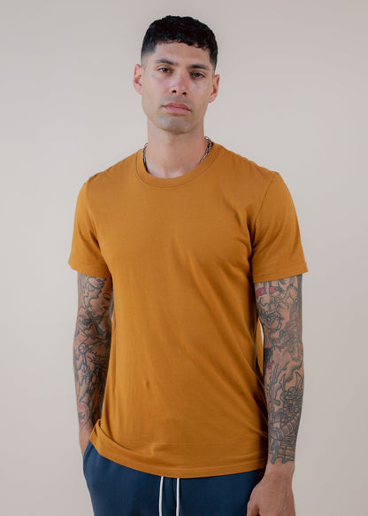 Man wearing butterscotch basic tee with tattoos, stylish men's fashion from MANN marketplace