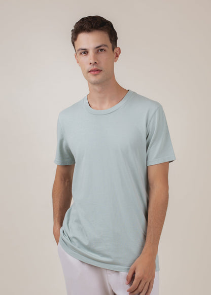 Man wearing a sage green basic tee, casual fashion for men by MANN marketplace