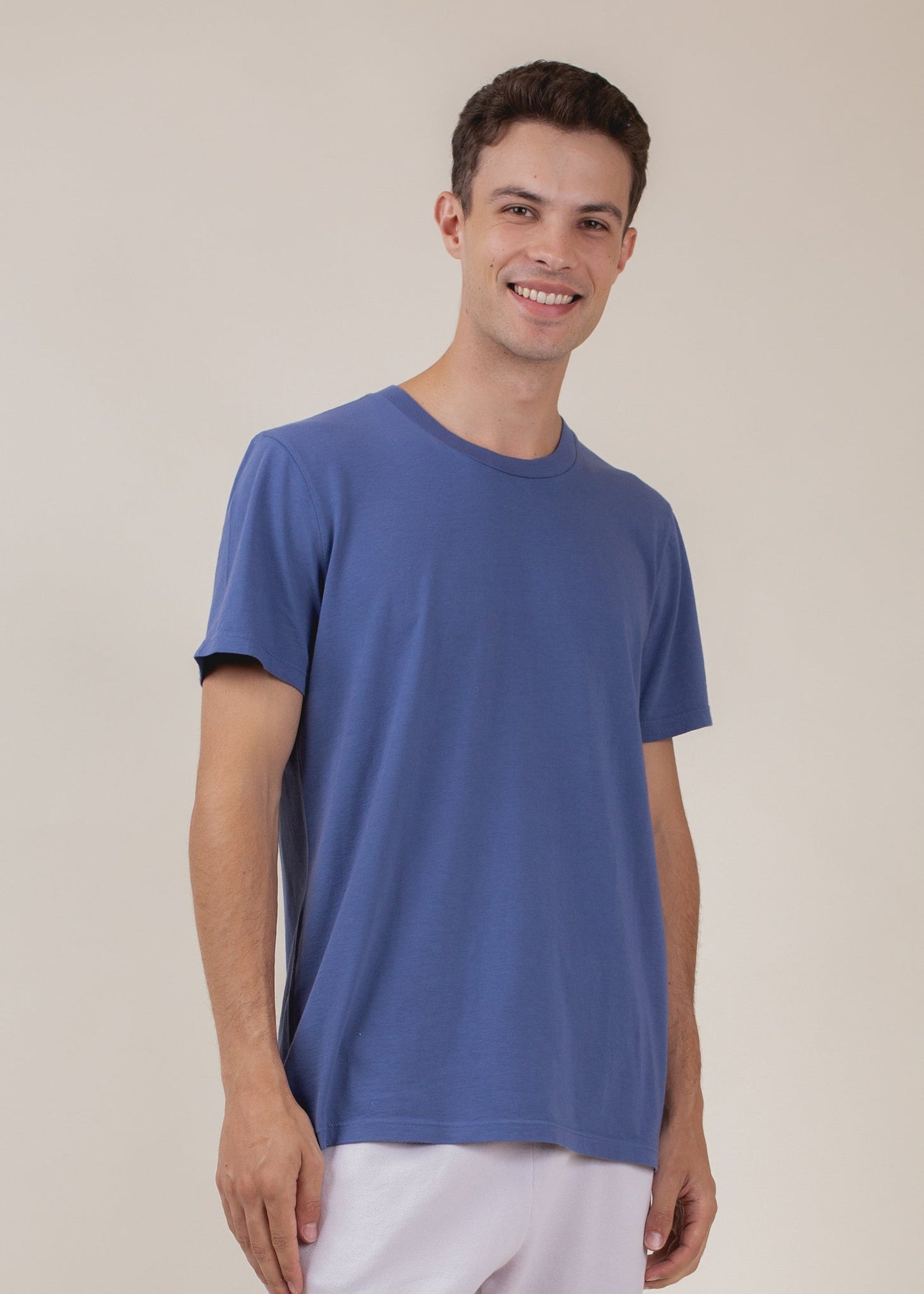 Man wearing a sapphire blue basic tee, casual men’s fashion for MANN marketplace