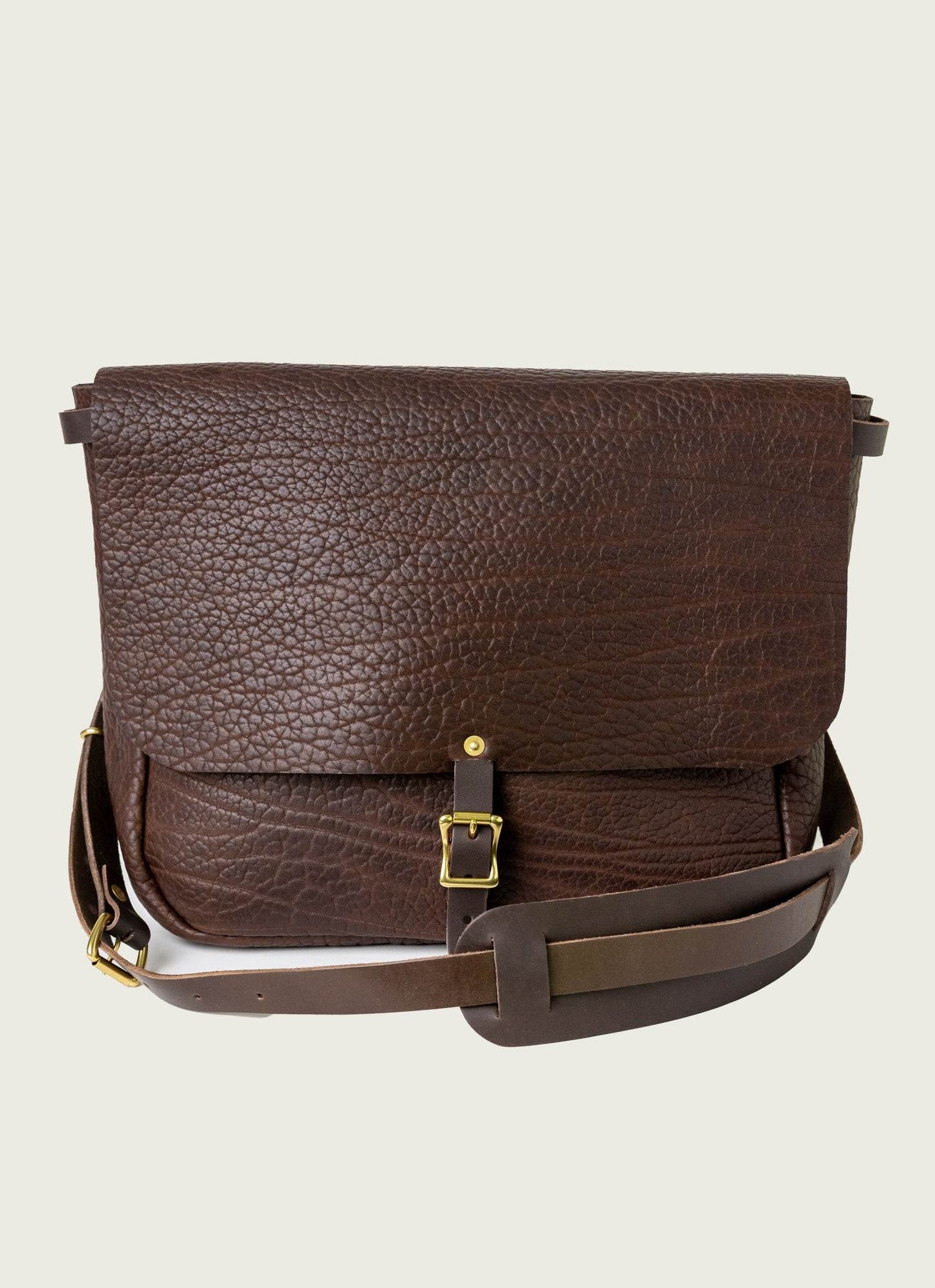 Brown textured leather messenger bag for men with gold buckle and adjustable shoulder strap