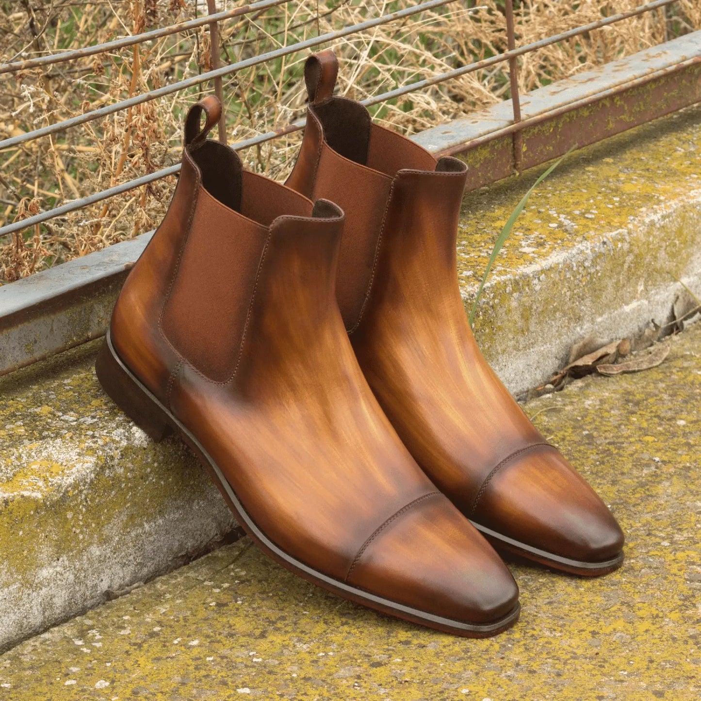Pair of brown leather Caratacos Patina Chelsea boots showcasing premium craftsmanship