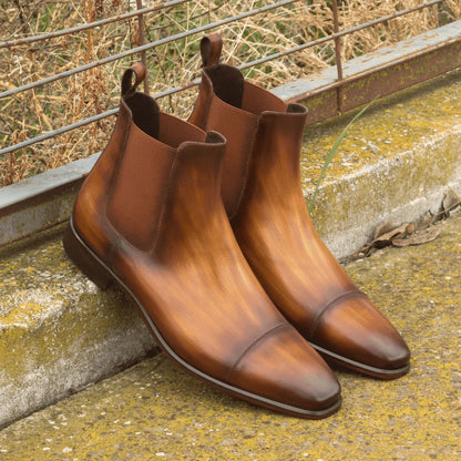 Pair of brown leather Caratacos Patina Chelsea boots showcasing premium craftsmanship