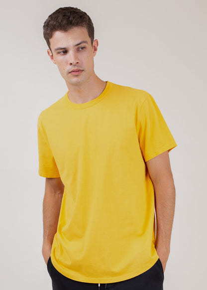 Man wearing classic gold short-sleeve tee, fashion for men by MANN marketplace