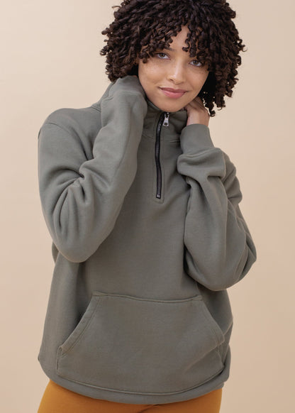 Model wearing artichoke green half-zip sweatshirt with front pocket, MANN fashion