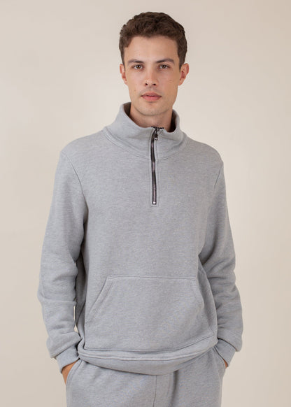 Man wearing a light grey half-zip sweatshirt with kangaroo pocket, casual menswear style