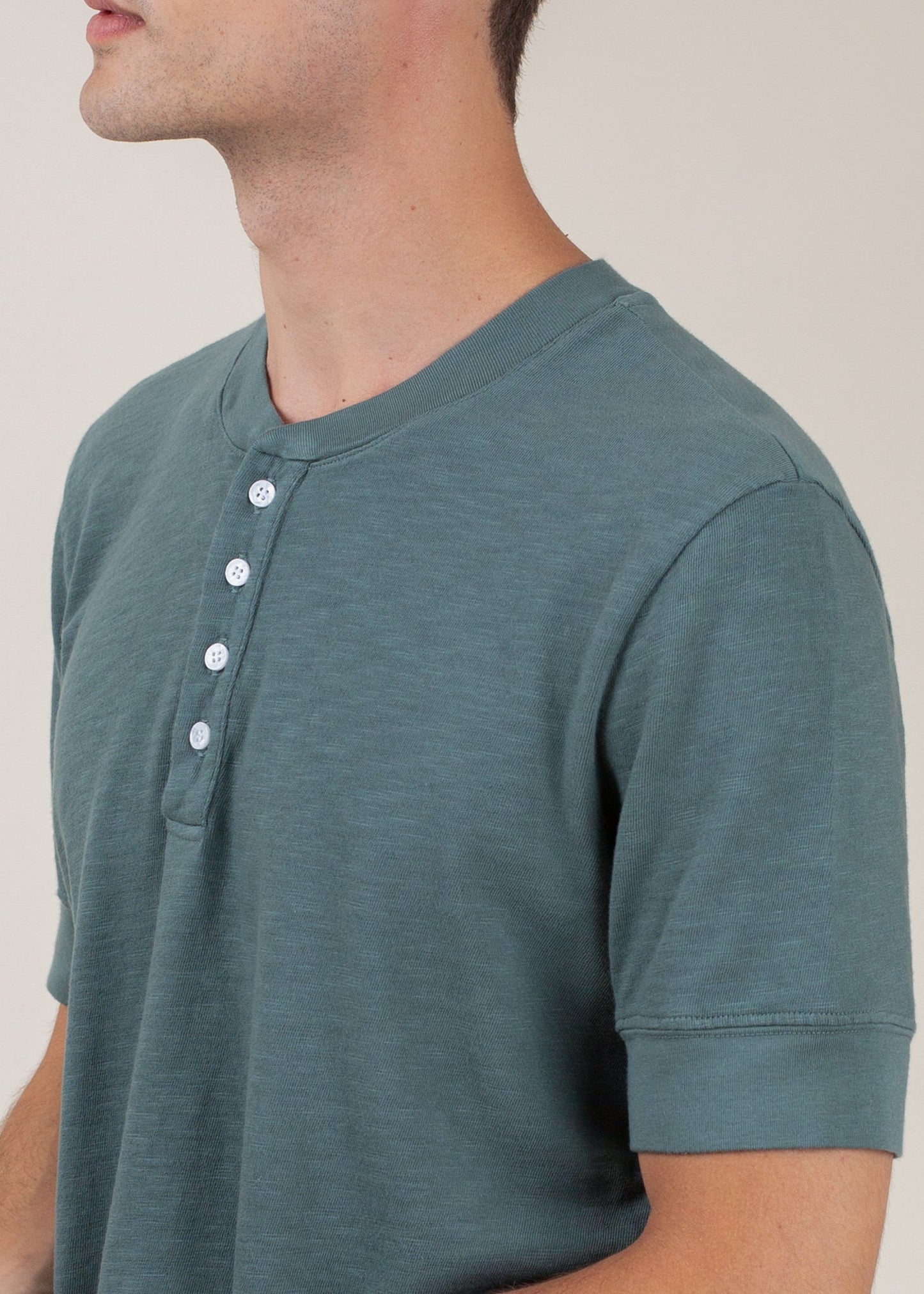 Men's pine green henley tee with short sleeves and button placket, modern casual style