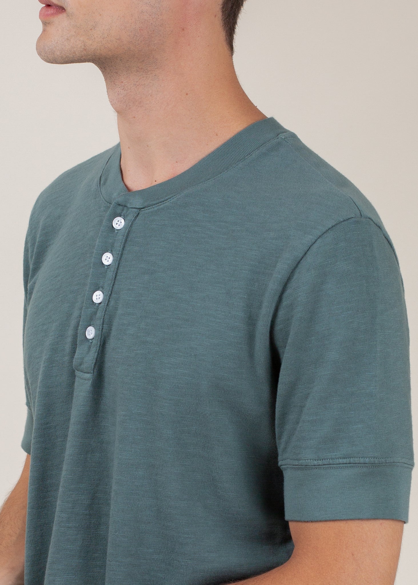 Men's pine green henley tee with short sleeves and button placket, modern casual style