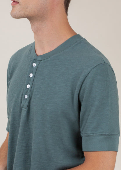Men's pine green henley tee with short sleeves and button placket, modern casual style