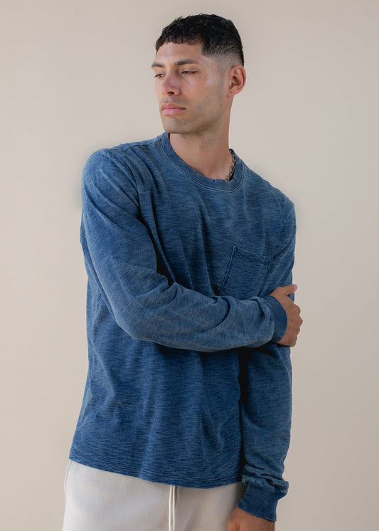 Man wearing indigo long sleeve t-shirt with chest pocket, casual men's fashion