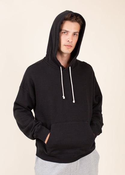 Man in black hoodie and gray sweatpants, casual men's fashion for MANN marketplace