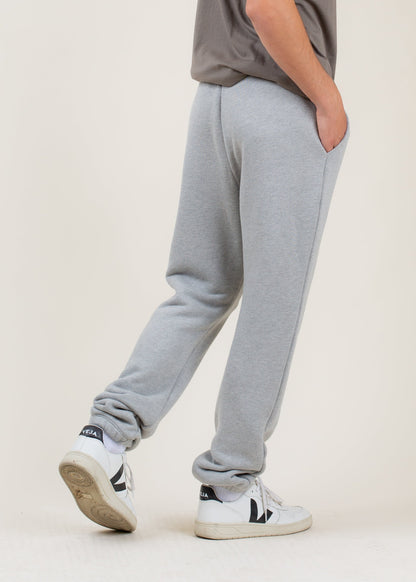 Man wearing grey sweatpants and white Veja sneakers, casual men's fashion on MANN