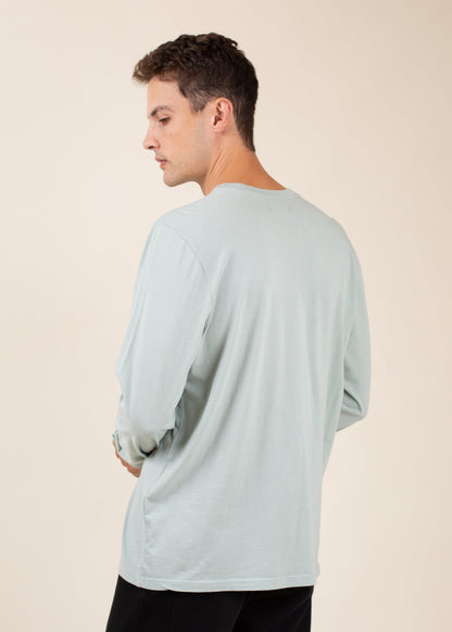 Man in light blue long sleeve shirt, side view, minimalist fashion, MANN men's marketplace