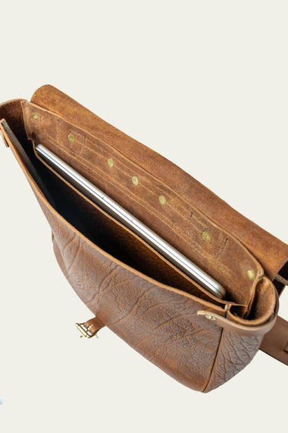 Brown leather laptop bag with open top showing laptop compartment, stylish men's accessory