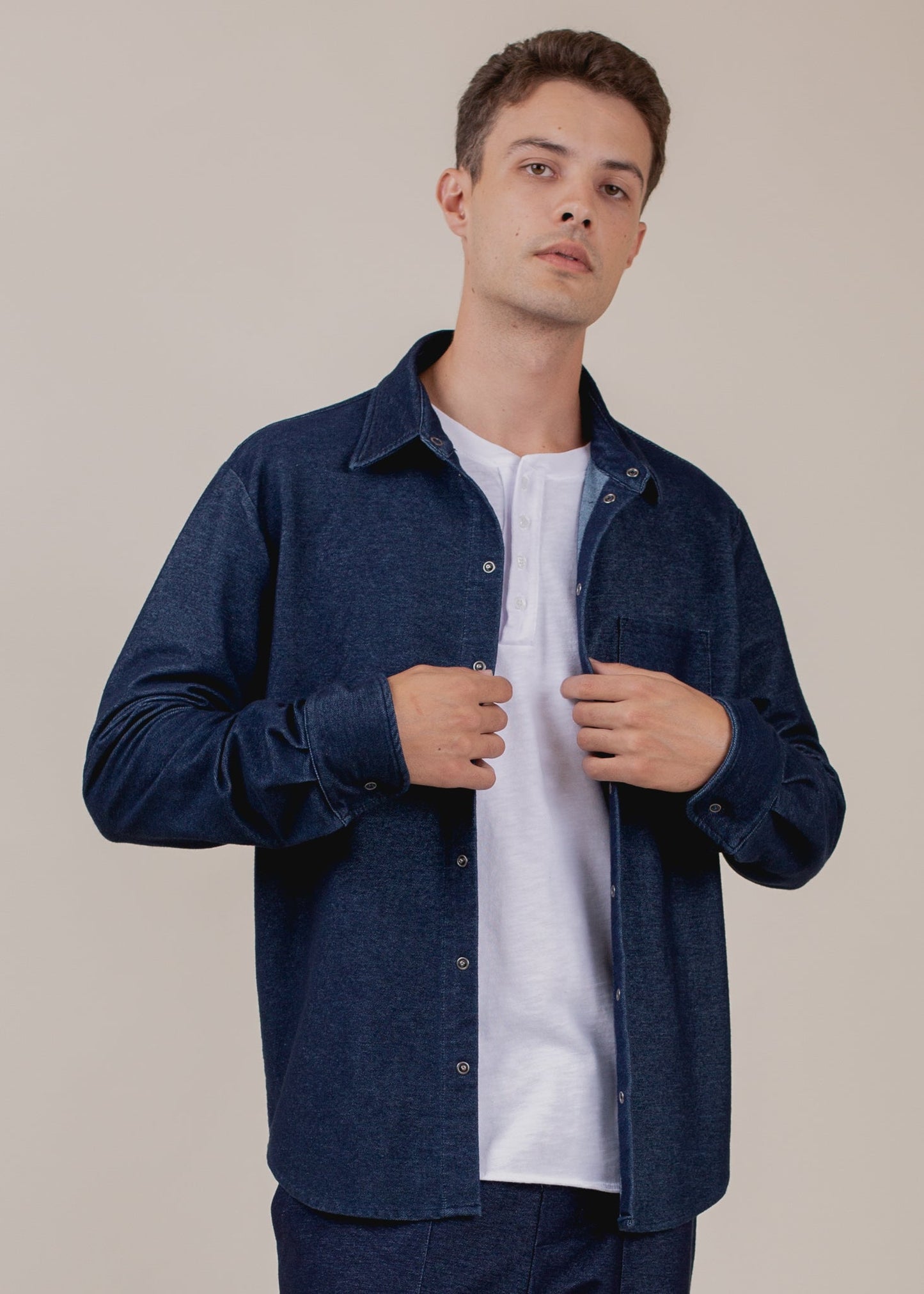 Man modeling navy indigo button-down shirt over white T-shirt, stylish men's fashion