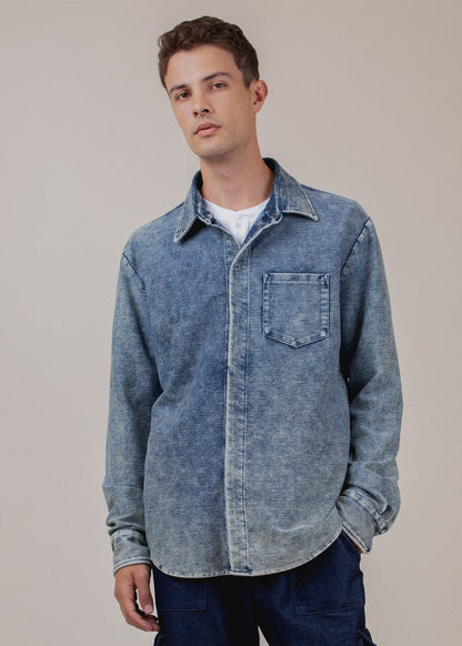 Man wearing indigo mineral wash button-down shirt, casual fashion style, neutral background