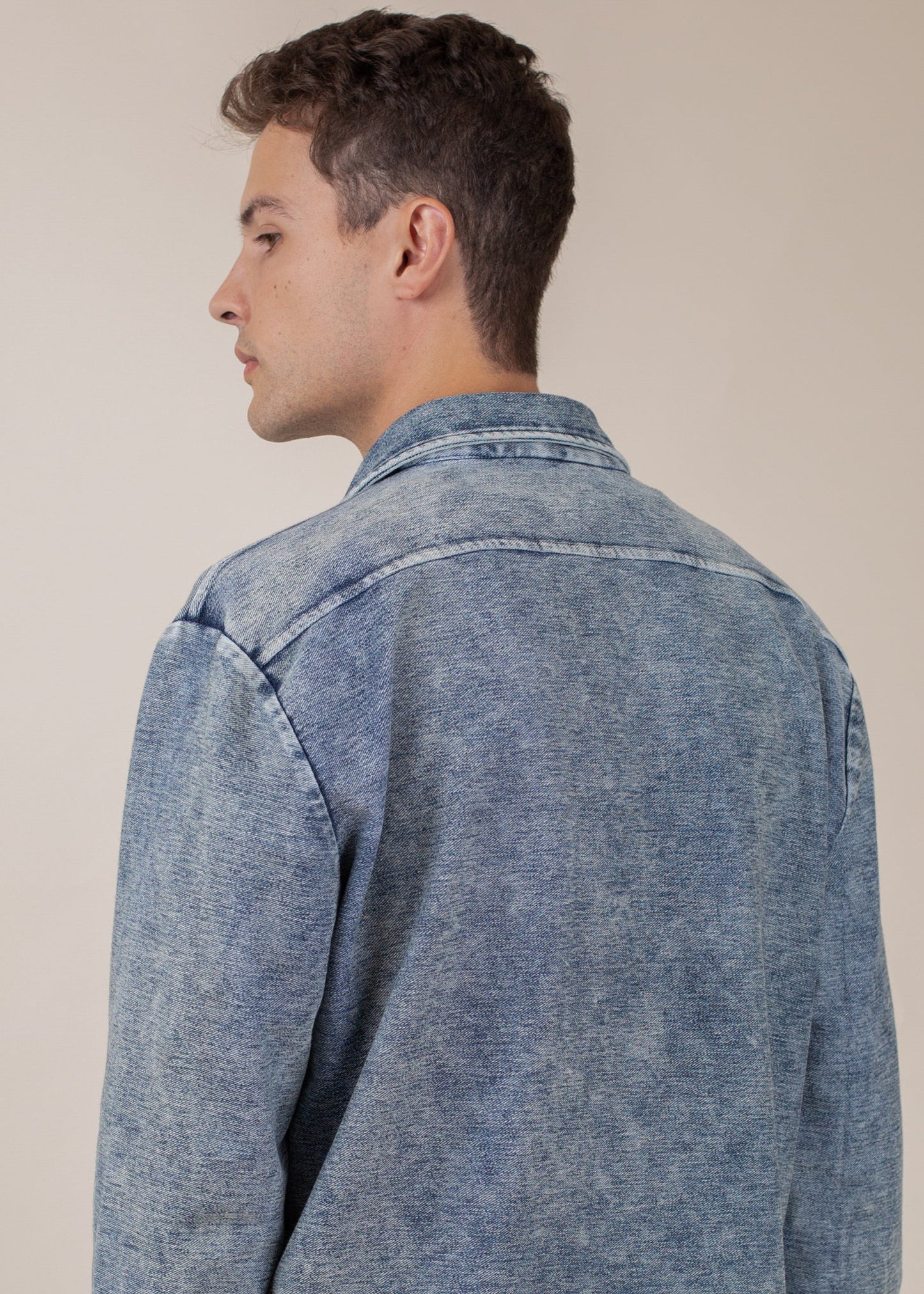 Man wearing indigo mineral wash button-down shirt, back detail, Mann men's fashion