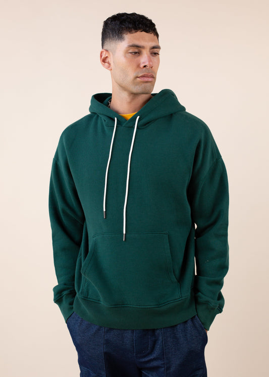 Man wearing forest green hoodie with white drawstrings, fashion by MANN marketplace