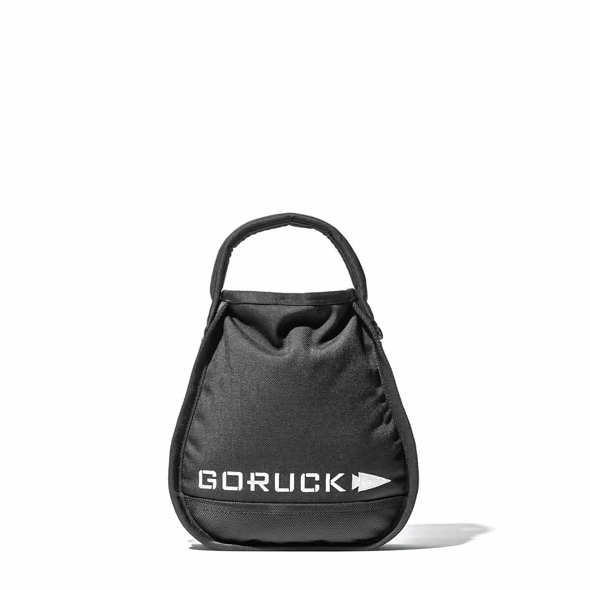 GORUCK black sandbag kettlebell with handle, durable workout gear for men on white backdrop