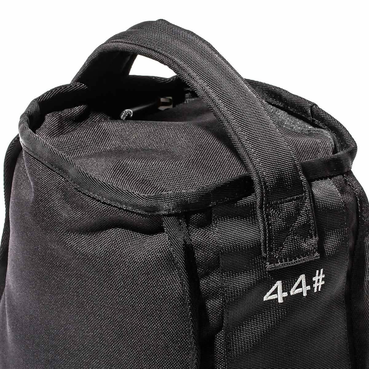 Close-up of black gym sandbag with handle and '44#' embroidered, men's fitness gear