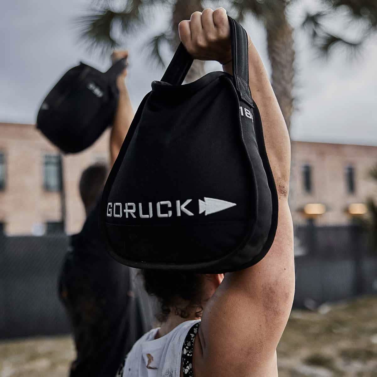 Man outdoors lifting GORUCK workout sandbag, fitness gear for men on MANN marketplace
