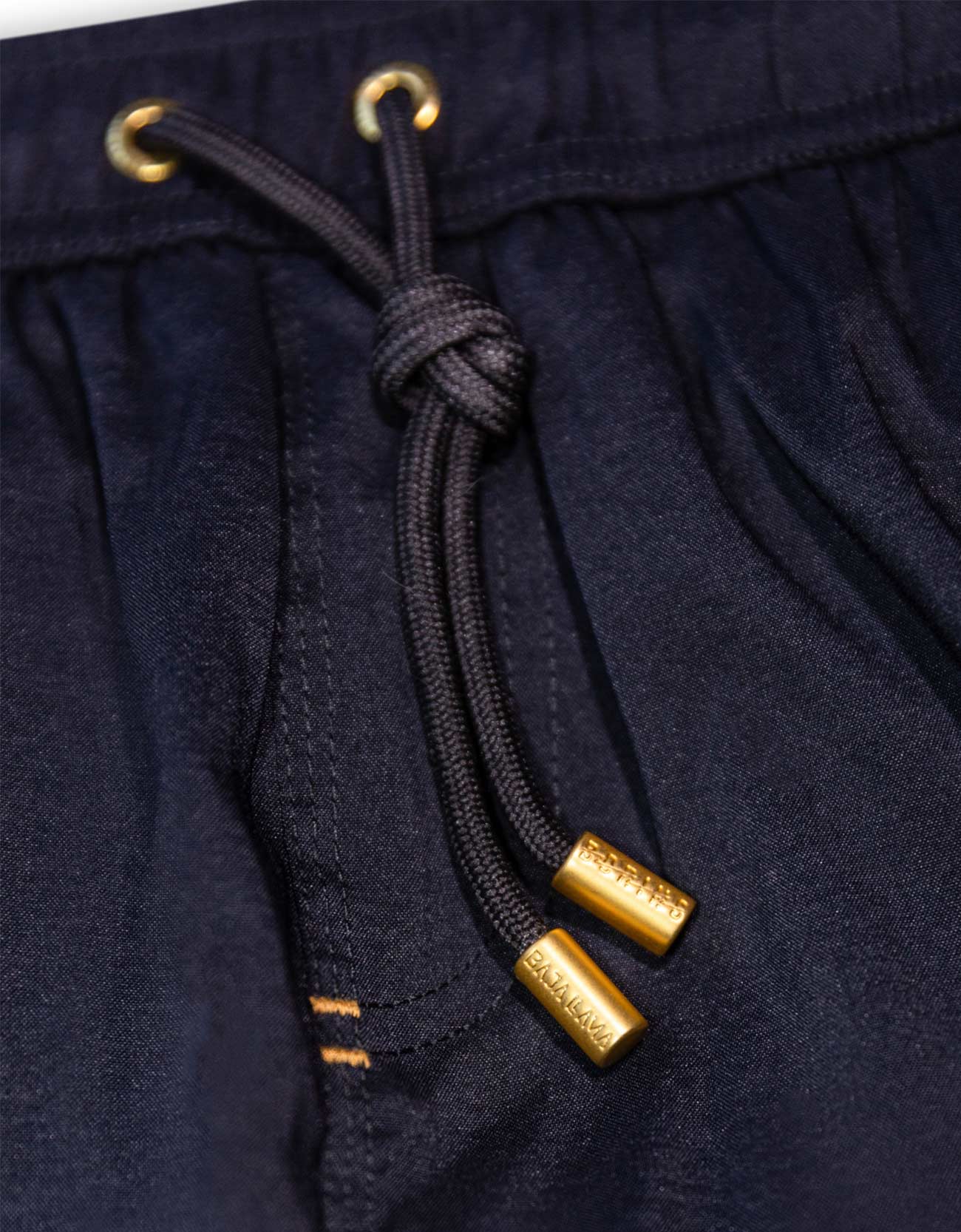 Men's black swimsuit. 6 inch stretch volley trunks. Gold finishes. Functional zipper pockets with internal stash pocket.