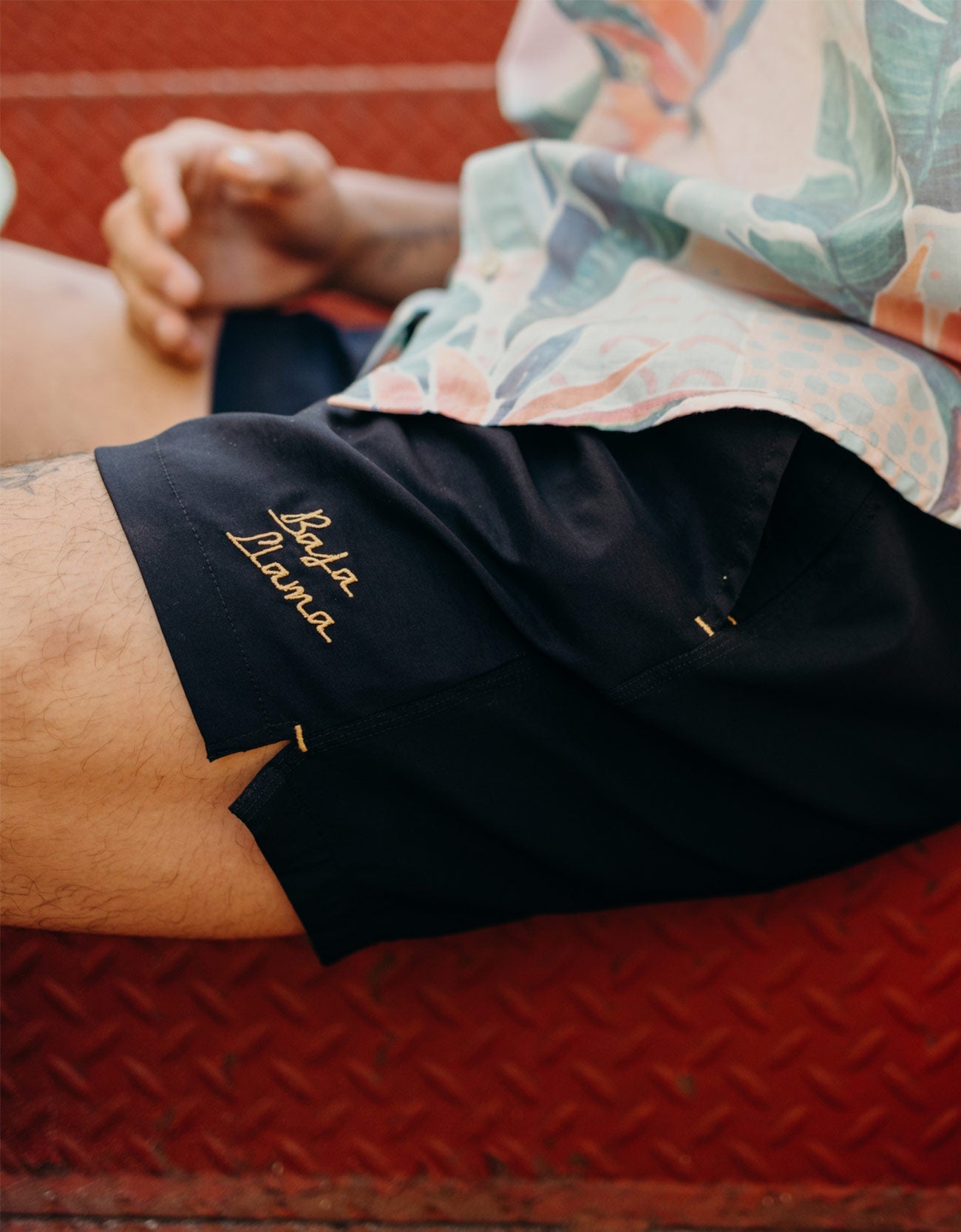 Men's black swimsuit. 6 inch stretch volley trunks. Gold finishes. Functional zipper pockets with internal stash pocket.