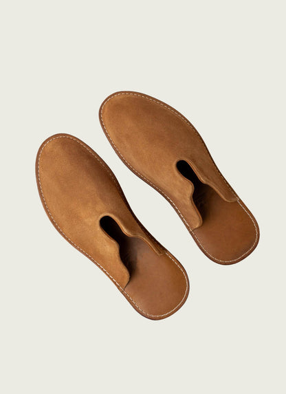 Tan suede men’s slip-on mules with exposed stitching, curated fashion from MANN marketplace