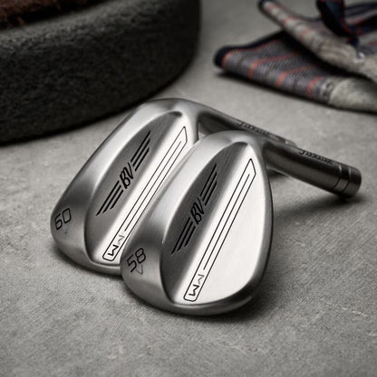 Two brushed metal golf wedges with BV branding on a gray surface, curated for men by MANN